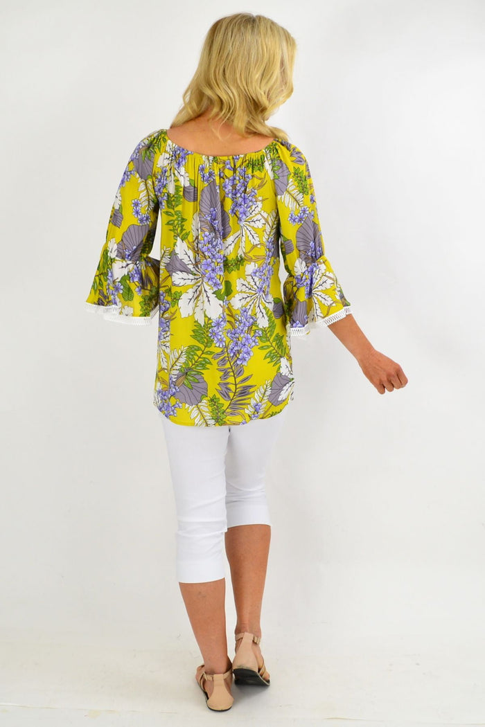 Mustard tropical floral off-shoulder tassel tunic top by Missy Q with colorful summer print and relaxed fit.