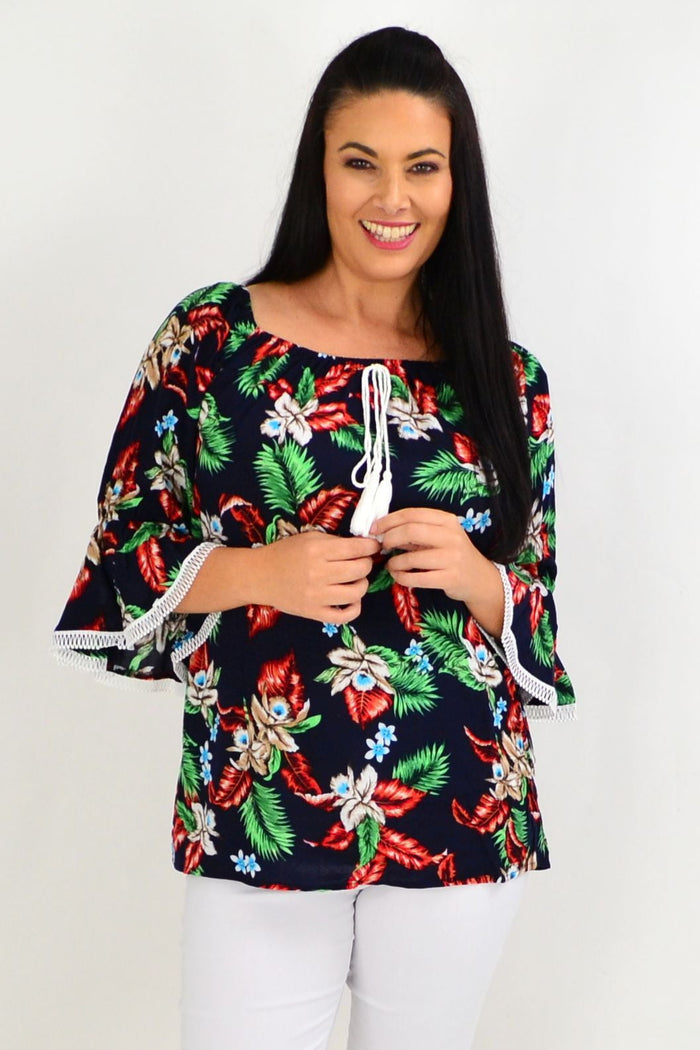 Navy tropical tassel off-shoulder tunic top with black boho floral pattern by Missy Q, made of lightweight rayon fabric.