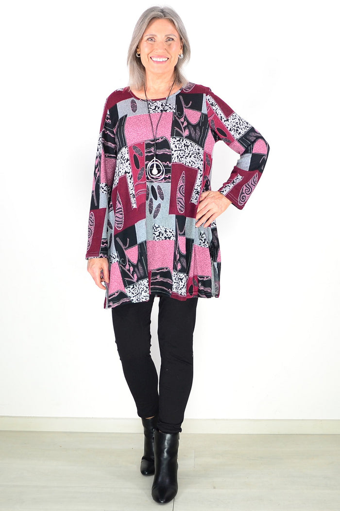 Pink abstract print fleece tunic top by Hourglass, featuring a cozy, stylish design with vibrant patterns and soft fabric.