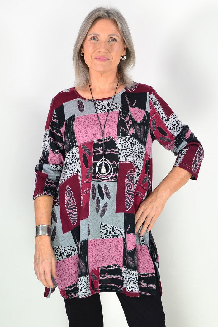 Pink abstract print fleece tunic top by Hourglass, featuring a cozy fit and stylish design, shown on a model.