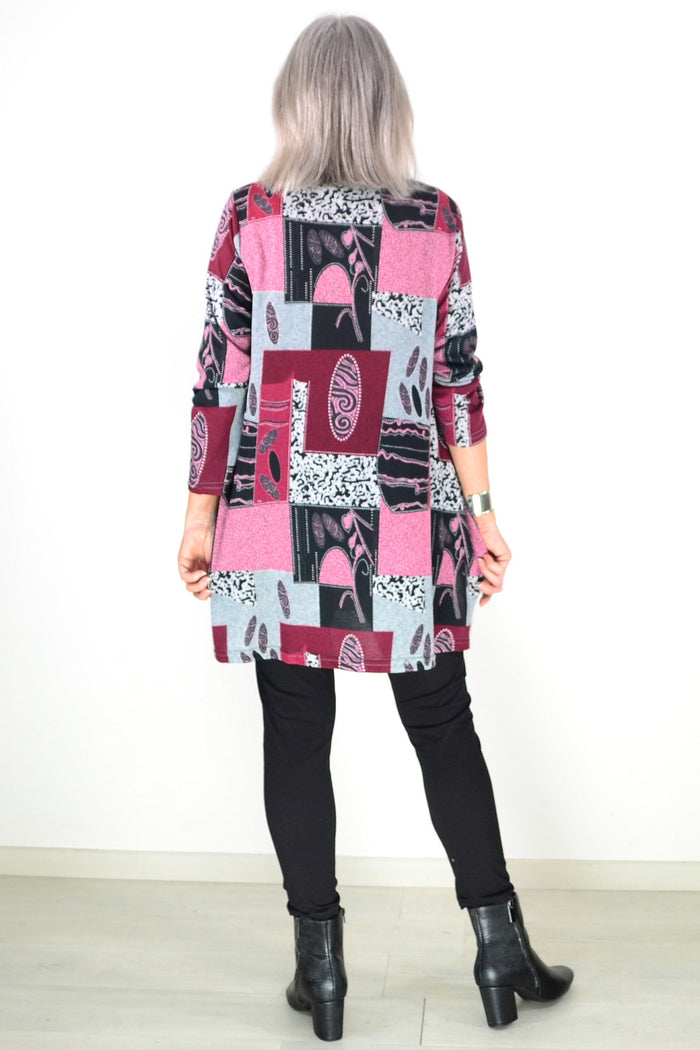 Pink abstract print fleece tunic top by Hourglass, showing the cozy, loose-fitting style with vibrant pattern details.