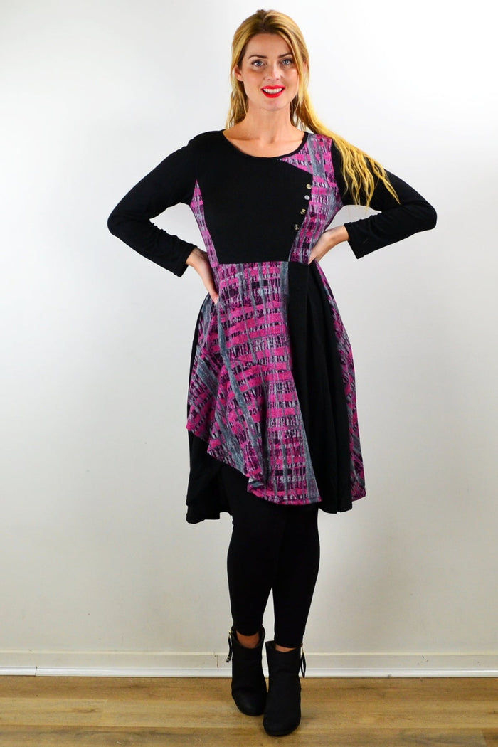 Pink and grey abstract print Hourglass tunic dress hanging on a mannequin, showcasing its flowy fabric and stylish design.