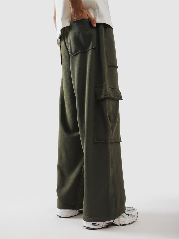 Raw edge flap pockets stacked down the olive leg - GROOVY Pakistan