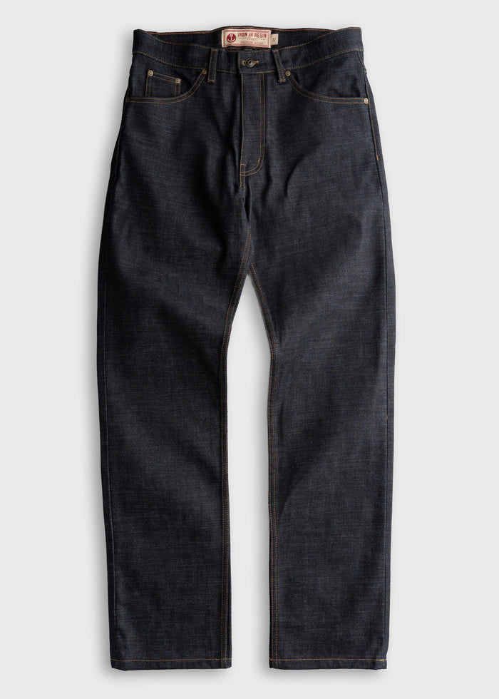 Dark denim jeans with contrast stitching, featuring a button fly and five-pocket design, laid flat on a light background.