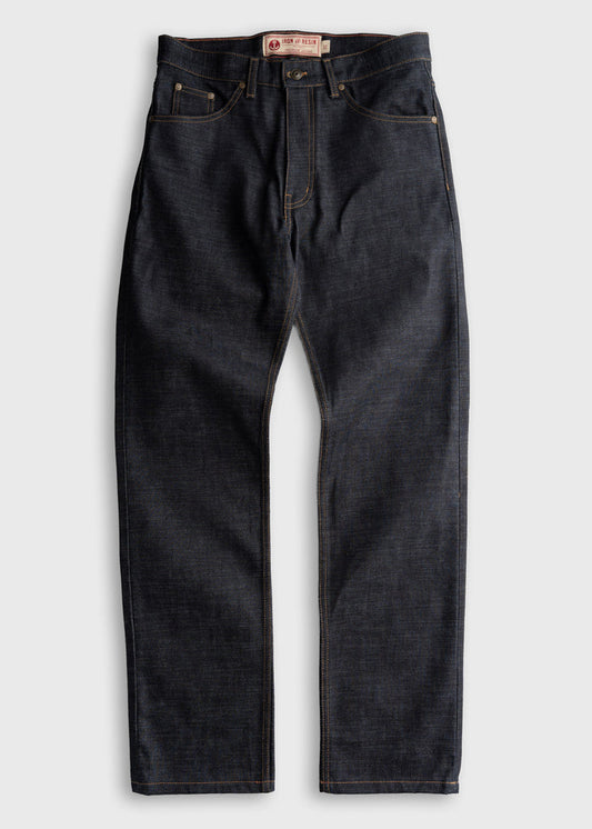 Dark denim jeans with contrast stitching, featuring a button fly and five-pocket design, laid flat on a light background.