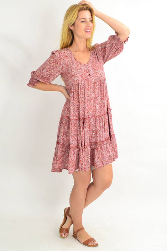 Rust smocking sleeve tiered tunic dress by Silver Wishes, featuring long sleeves and a flowing tiered design.
