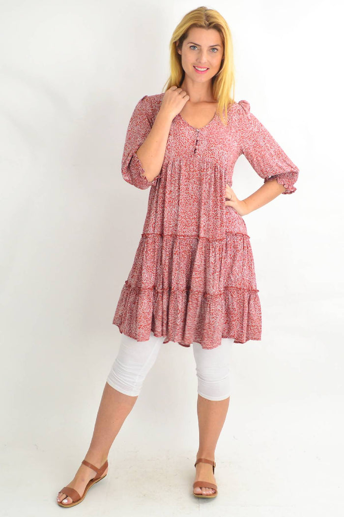 Red tiered tunic dress with smocking sleeves by Silver Wishes, featuring a relaxed fit and vibrant spot pattern.