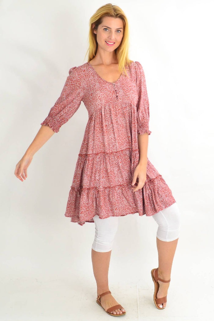 Rust colored smocking sleeve tiered tunic dress by Silver Wishes, featuring flowy fabric and tiered design with smocked sleeves.