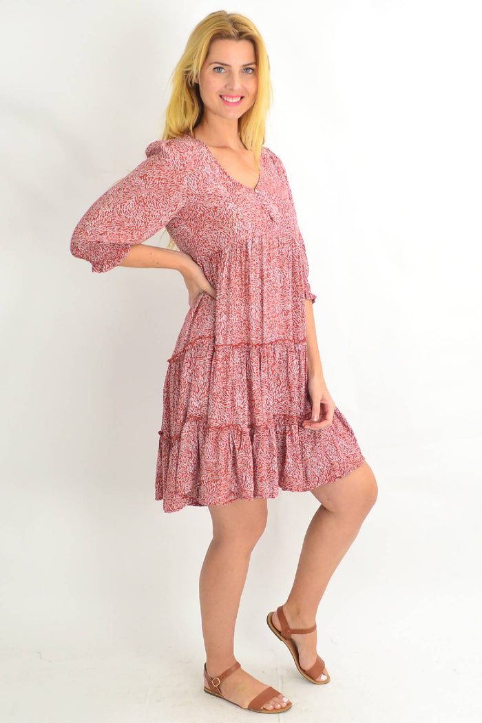 Rust smocking sleeve tiered tunic dress by Silver Wishes featuring ruffled sleeves and a flowy, boho-inspired silhouette.