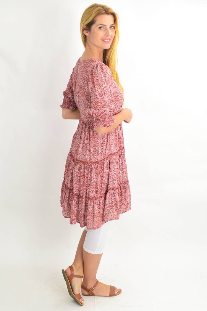 Red rust-colored smocking sleeve tiered tunic dress by Silver Wishes, featuring a stylish and comfortable design.