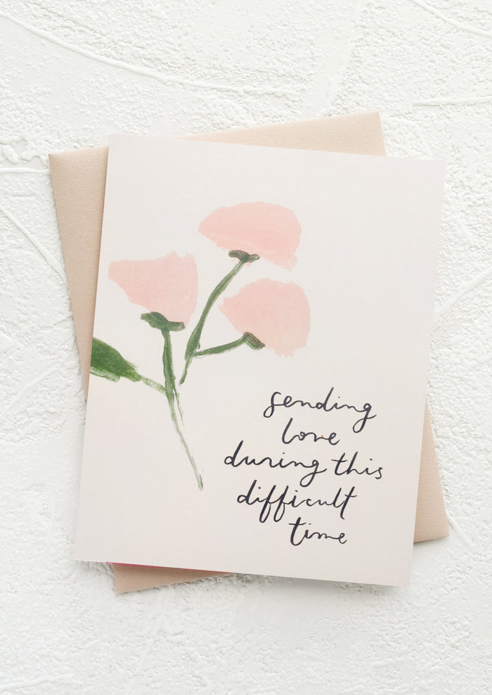 A greeting card with text reading "Sending love during this difficult time".