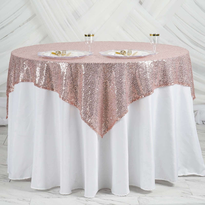 Rose gold sequin tablecloth draped elegantly over a white table.