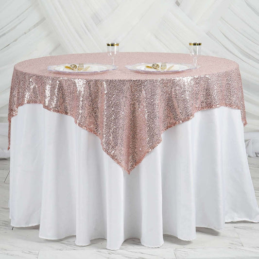 Rose gold sequin tablecloth draped elegantly over a white table.
