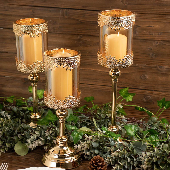 Elegant gold and glass candle holders with faux candles, set on a wooden table.