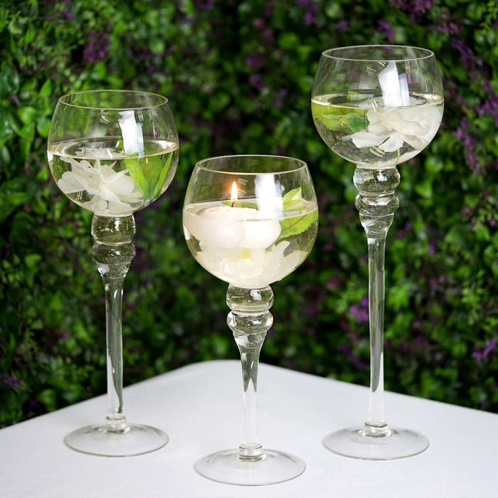 Elegant glassware with decorative elements, set against a lush green background.