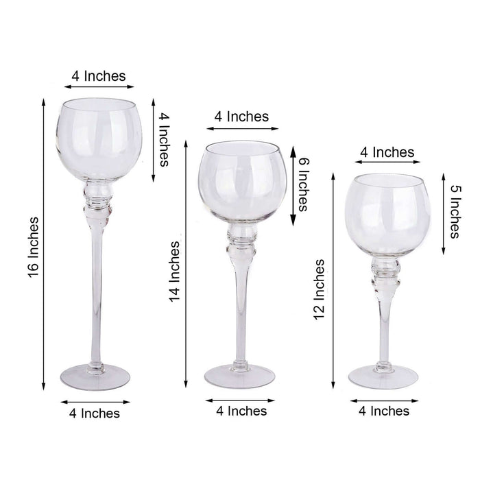 Set of three elegant clear glass candle holders in various heights.