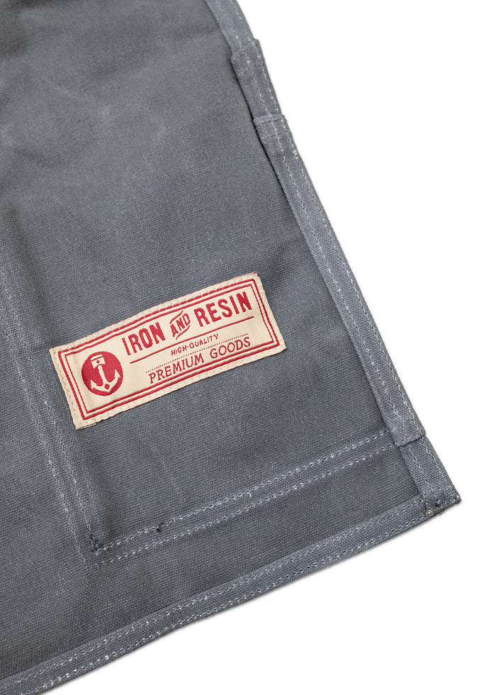 Gray fabric with a red "Iron and Resin" label, featuring an anchor logo and "Premium Goods" text, stitched on the corner.
