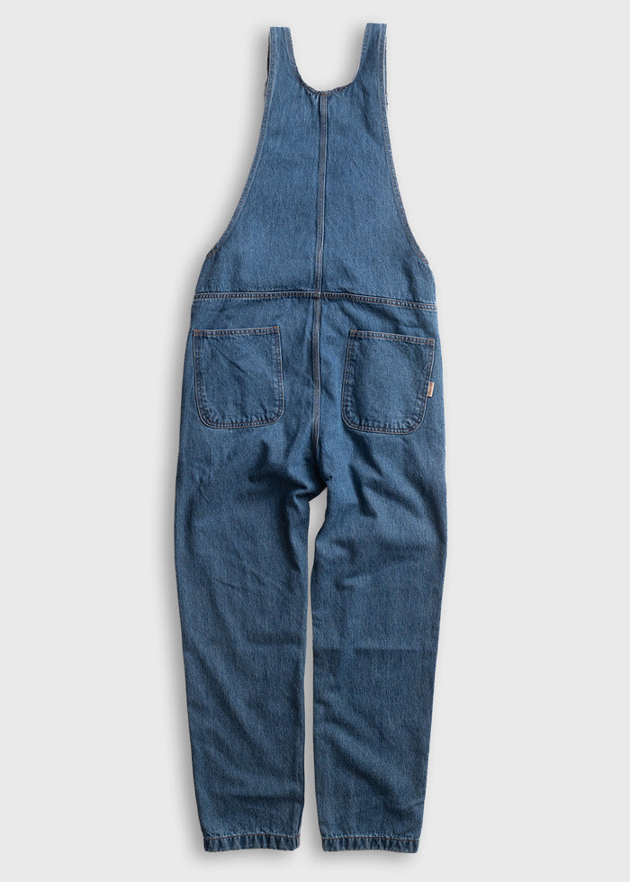 Blue denim overalls with front pockets, laid flat on a light background. Simple, casual style, perfect for everyday wear.