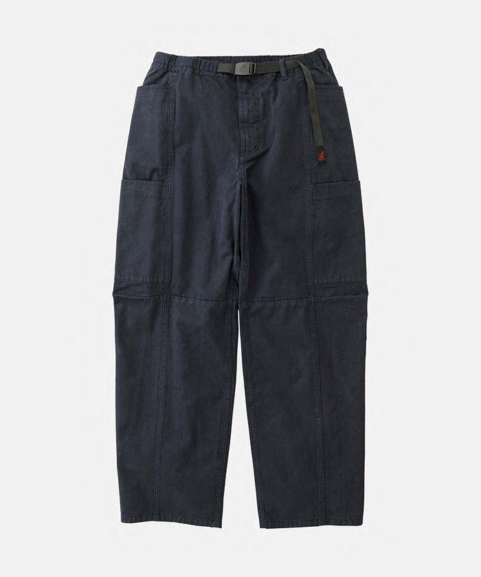 Double navy Gramicci Voyager Pants with a belt against a light-tone background.