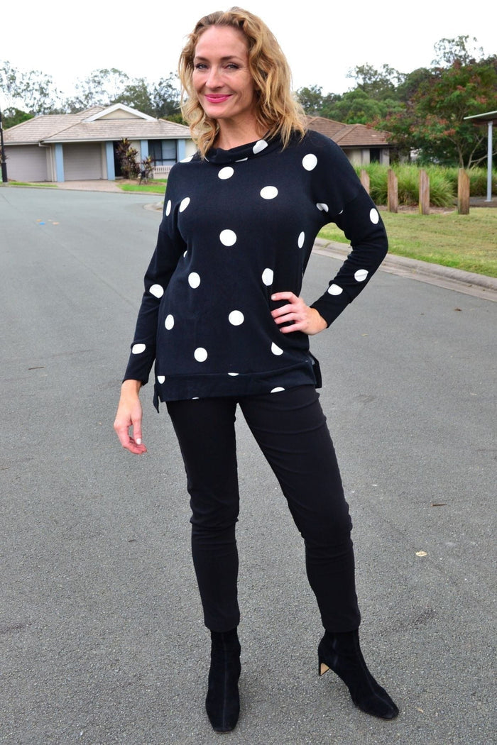 White Wishstone long sleeve fleece tunic top with white spots, casual fit, soft fabric, and crew neckline, shown on a mannequin.