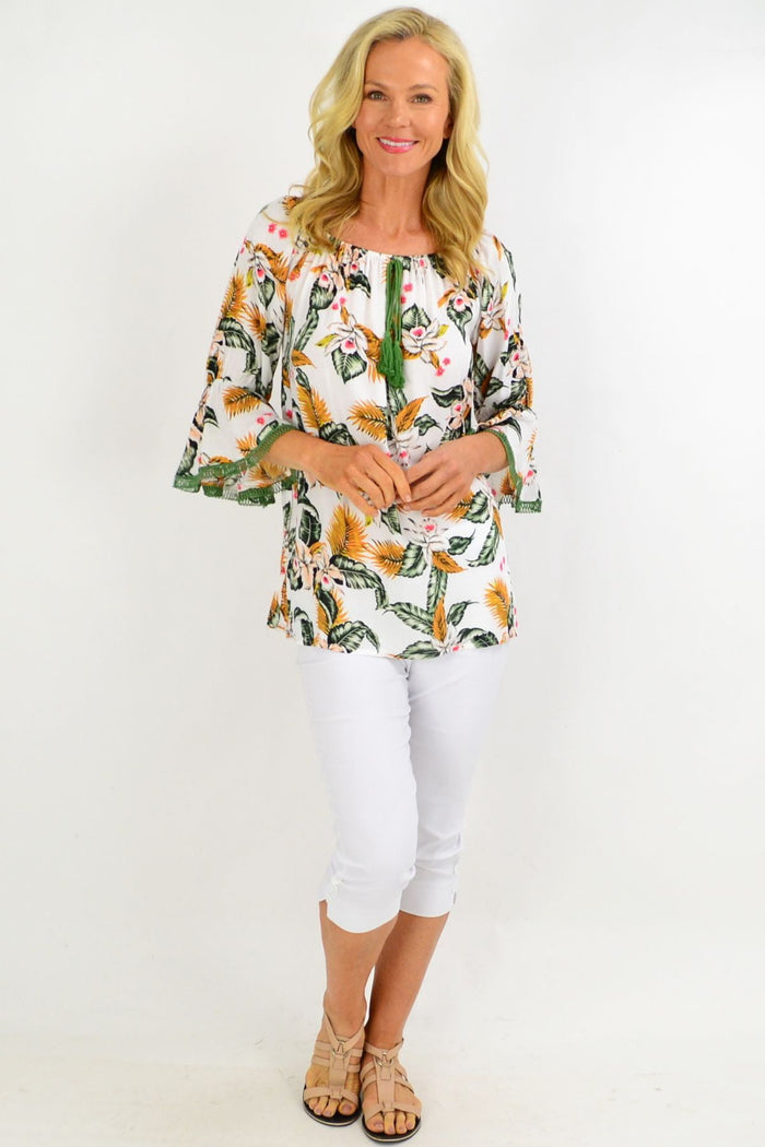 White tropical tassel off-shoulder tunic top with floral print and rayon fabric, stylish boho design by Missy Q.