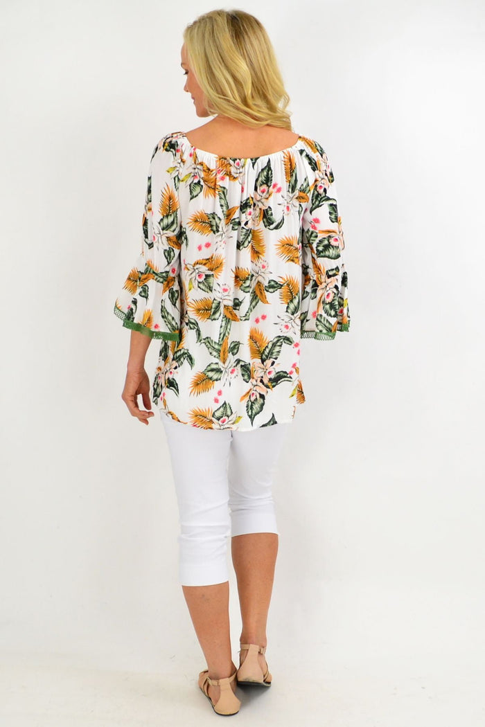 White tropical tassel off-shoulder rayon tunic top with floral boho design by Missy Q.