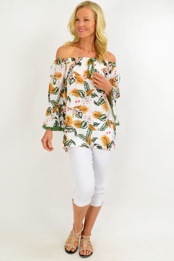 White tropical tassel off-shoulder boho tunic top with floral rayon fabric by Missy Q, featuring tassel accents and relaxed fit.