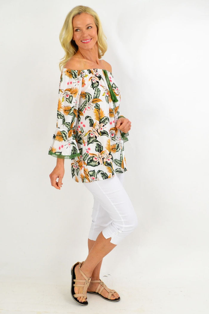 White tropical tassel off-shoulder tunic top with boho floral pattern by Missy Q, made of lightweight rayon fabric.