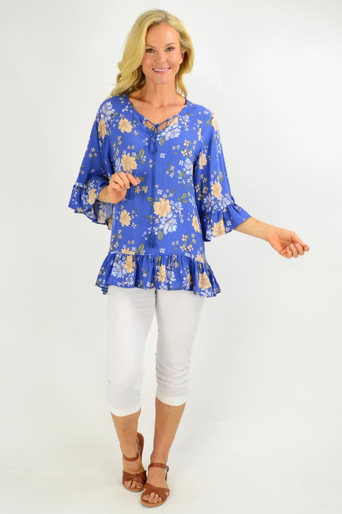 Blue floral tunic top with wide sleeves from New U Collection, featuring a relaxed fit and vibrant floral pattern.
