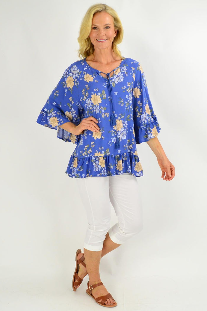 Blue floral tunic top with wide sleeves from New U Collection, featuring a relaxed fit and vibrant floral pattern.
