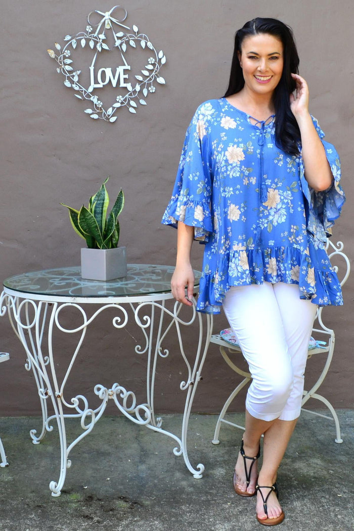 Blue floral tunic top with wide sleeves from New U Collection, featuring a relaxed fit and vibrant floral pattern.