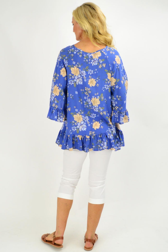 Blue floral tunic top with wide sleeves from New U Collection, featuring a relaxed fit and vibrant floral pattern.