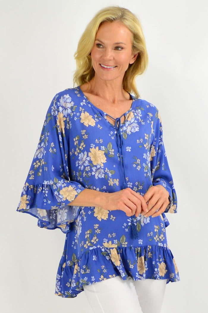 Blue floral tunic top with wide sleeves from New U collection, featuring a relaxed fit and vibrant flower pattern.