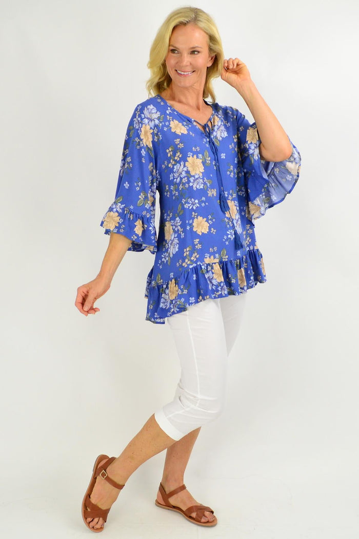 Blue floral tunic top with wide sleeves from New U Collection, featuring a relaxed fit and vibrant floral pattern.