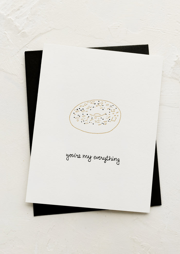 A greeting card with illustration of everything bagel and text below reading "You're my everything".