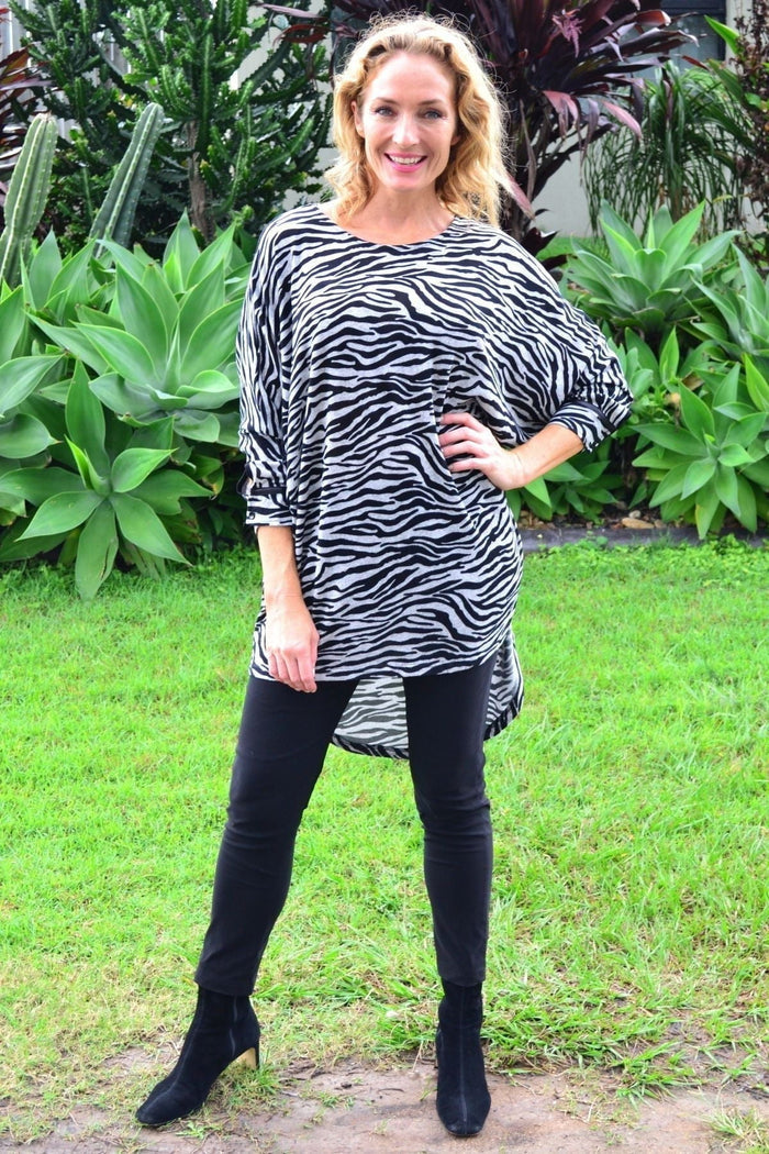 Zelma Zebra relaxed hi-low hem tunic top by Caroline Morgan, featuring a zebra print fabric and casual fit.