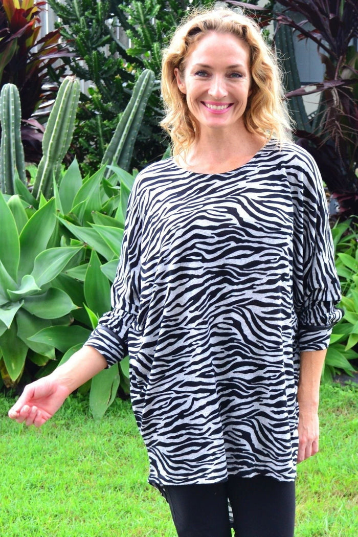 Caroline Morgan Zelma Zebra relaxed hi-low hem tunic top featuring a black and white zebra print fabric.